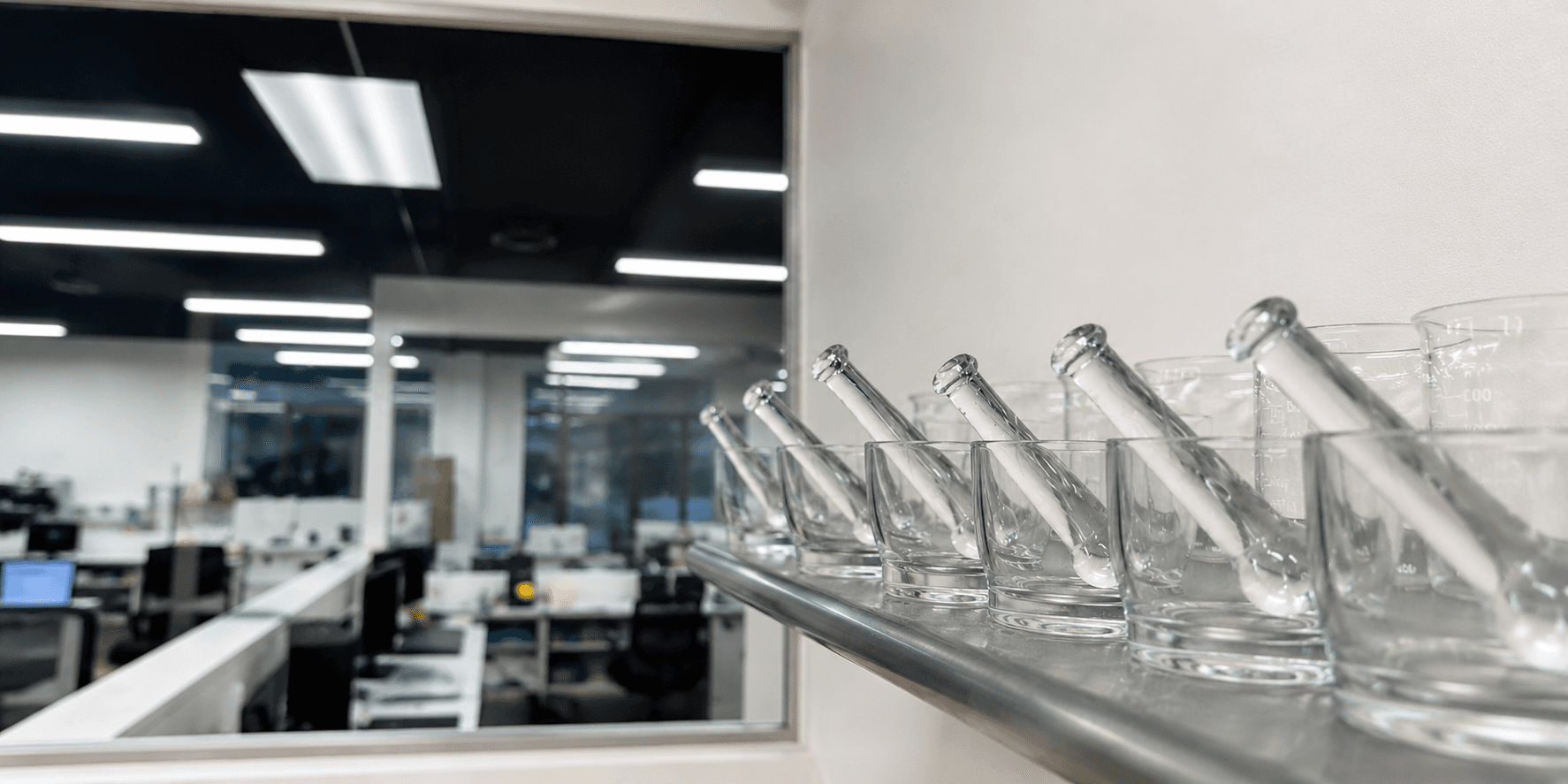 Rows of ceramic mortars and pestles on the compounding lab bench.