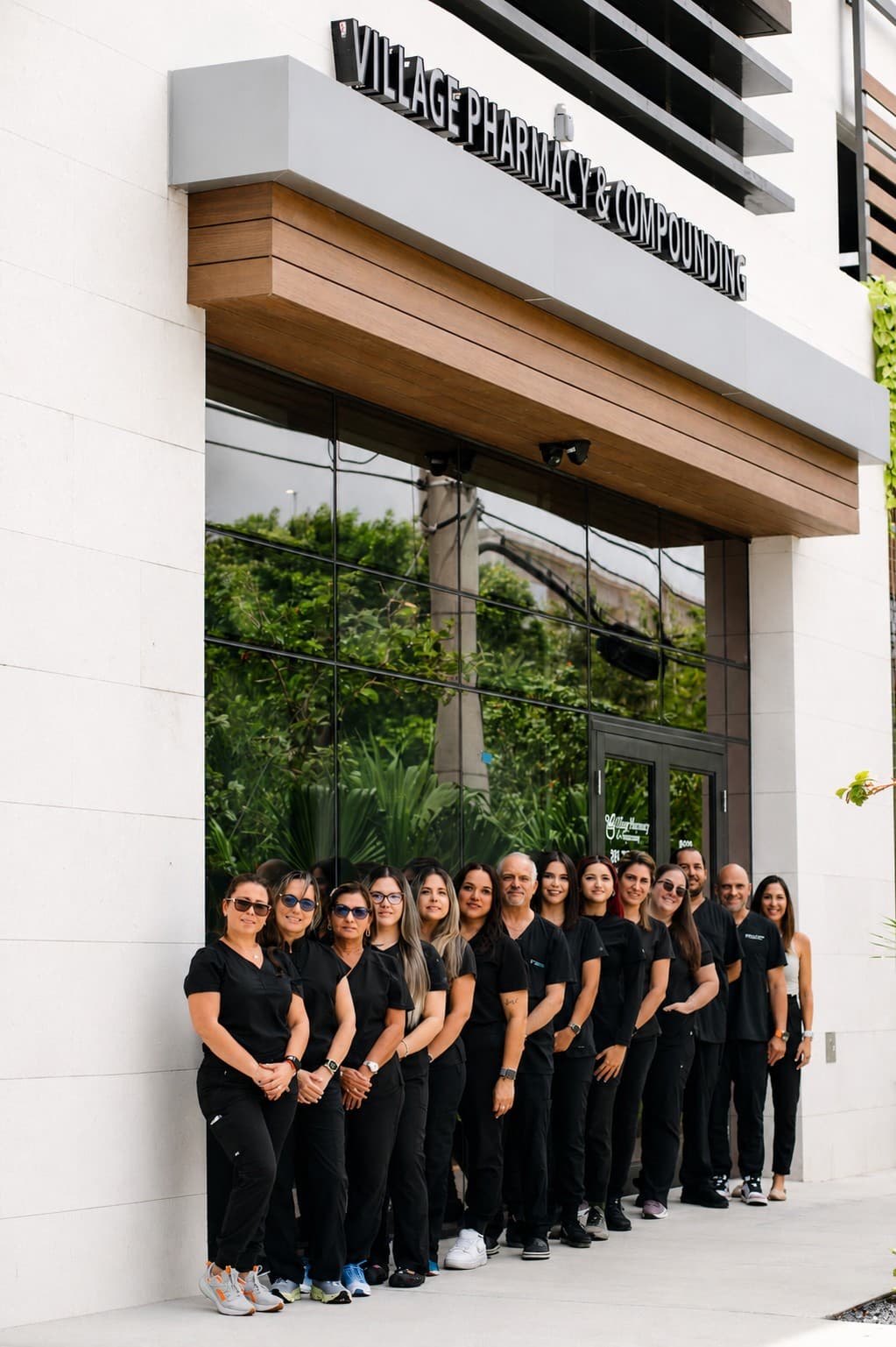 The Village Pharmacy & Compounding team standing together outside the pharmacy in Miami